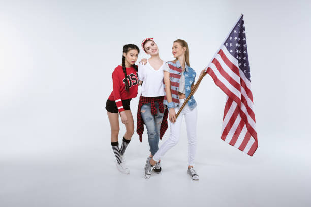 istock women standing with American flag isolated on white 693692824
