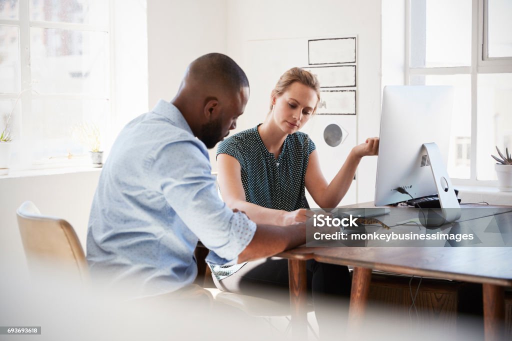 Man and woman with documents in an office, smiling, close up Discussion Stock Photo