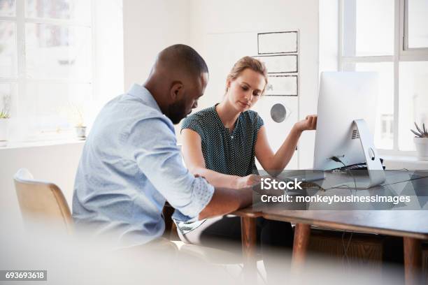 Man And Woman With Documents In An Office Smiling Close Up Stock Photo - Download Image Now