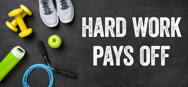 istock Fitness equipment on a dark background - Hard work pays off 693694052