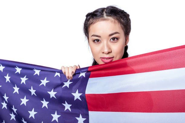 istock woman posing with american flag isolated on white 693694146