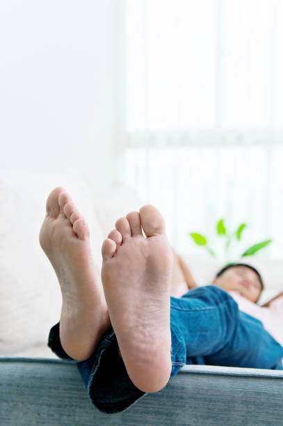 istock Man slipping on the sofa with feet up 693696068