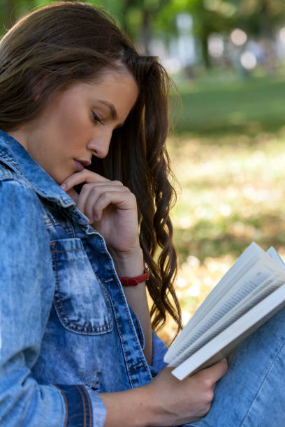 istock Portrait of a young beautiful thoughtfully reading a book 693696500