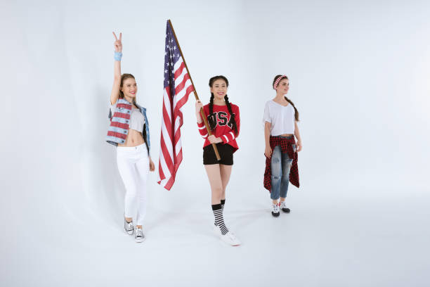 istock young women walking with american flag isolated on white 693697016
