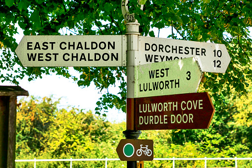 Multi-direction signpost pointing traffic around the Lulworth area of Dorset, UK