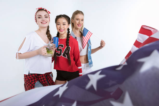 istock young women with american flag looking at camera and drinking beverages, 693698228