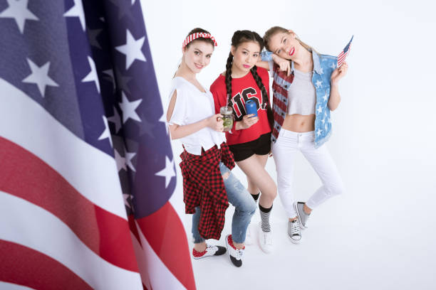 istock young women with american flag drinking beverages isolated on white 693701788