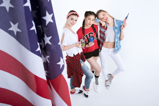 young women with american flag drinking beverages isolated on white, Independence Day Celebration