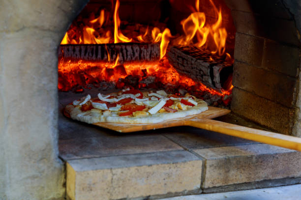 istock pizza cooked in a wood oven 693720470
