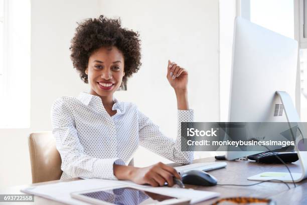 Young Black Woman In An Office Smiling To Camera Close Up Stock Photo - Download Image Now