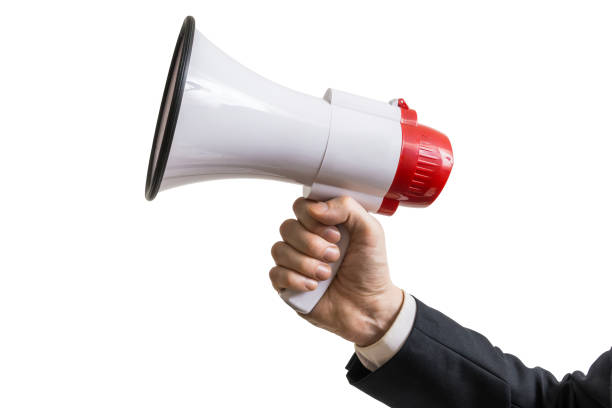 Announcement concept. Hand holds megaphone. Isolated on white background. stock photo