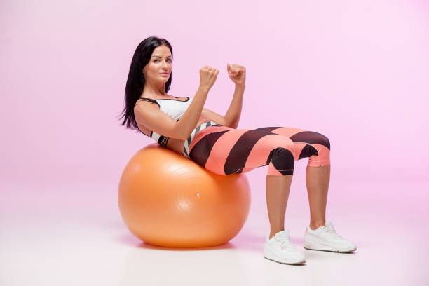 istock The woman training against pink studio 693734132