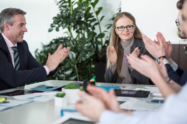 istock Clapping businesspeople at meeting 693736448