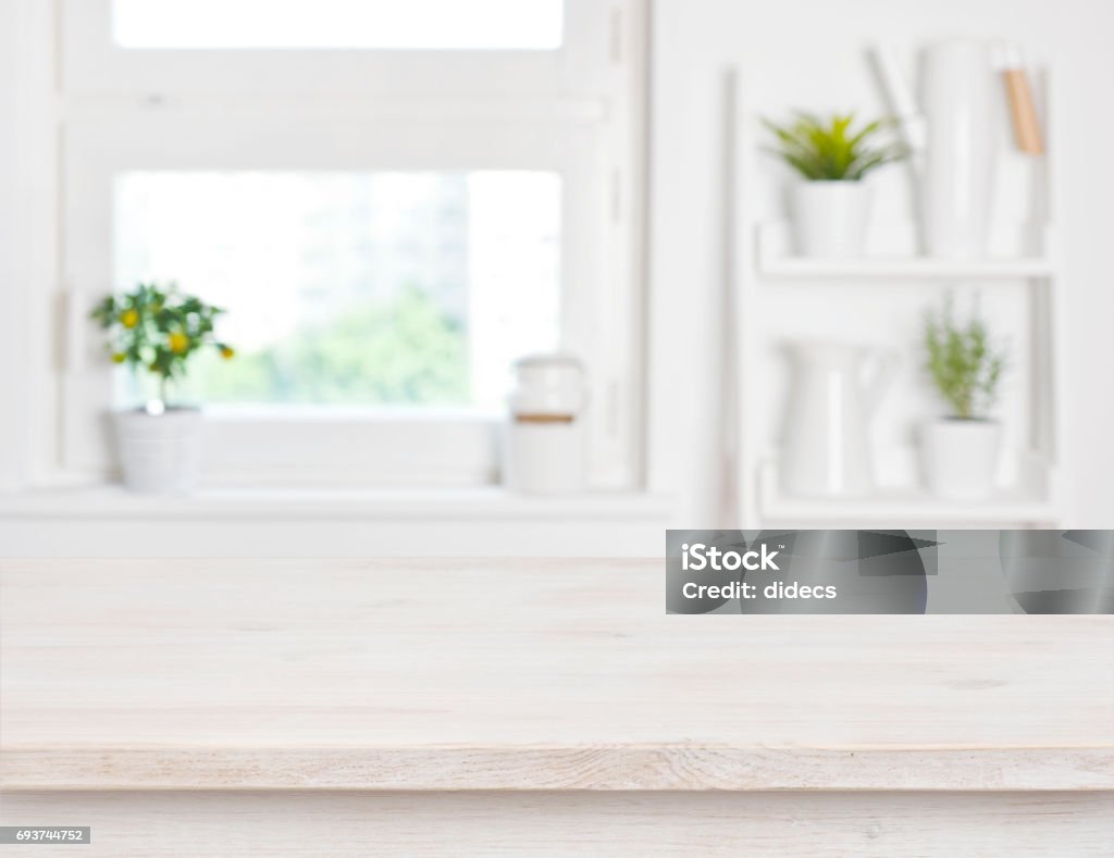 Empty bleached wooden table and kitchen window shelves blurred background Kitchen Stock Photo