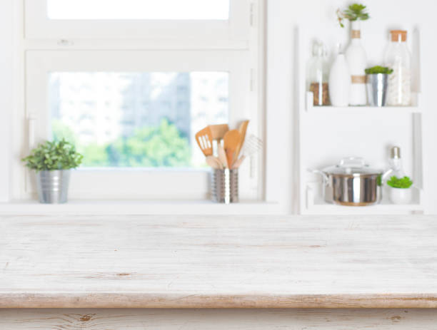 istock Empty table on blurred background of kitchen window and shelves 693744756