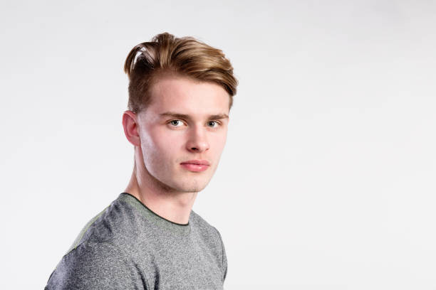 istock Young handsome hipster man in gray t-shirt, studio shot. 693744780