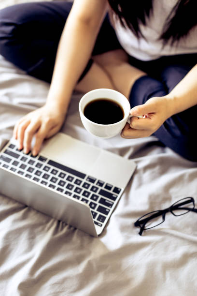 istock Woman working on a laptop in bed 693745300