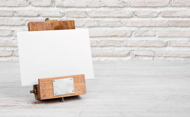 istock Mockup stand with paper on table over abstract brick wall 693745396