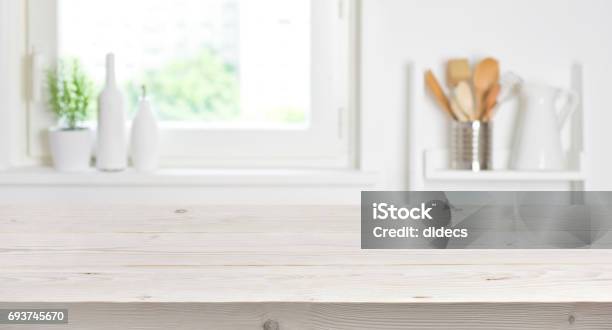 Wooden Table On Blurred Background Of Kitchen Window And Shelves Stock Photo - Download Image Now