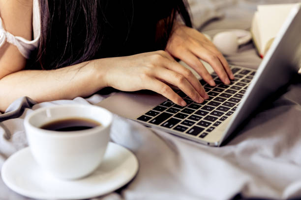 istock Woman working on a laptop in bed 693745986