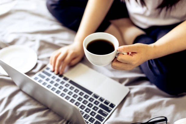 istock Woman working on a laptop in bed 693749196