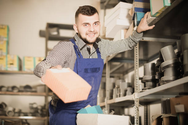 istock Professional man worker looking through sanitary drain pipes 693752316