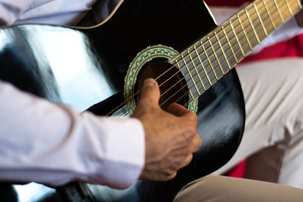 istock Closeup of a musician playing classical guitar 693756526