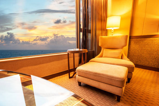 istock Sofa in living room in sunset at sea background 693760166