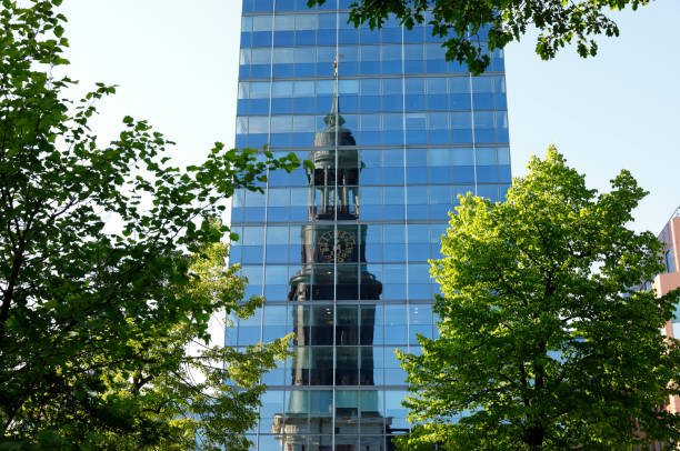 Protestant St. Michaelis Church (Sankt Michaelis Kirche, Michel) reflecting in the opposite glass facade in brilliant afternoon light.