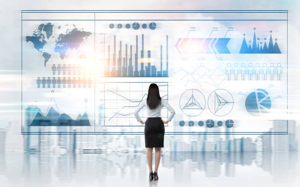 istock Businesswoman and graphs in sky 693767352