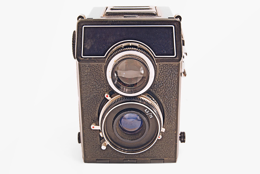 Old Soviet film camera with lens on white background close-up