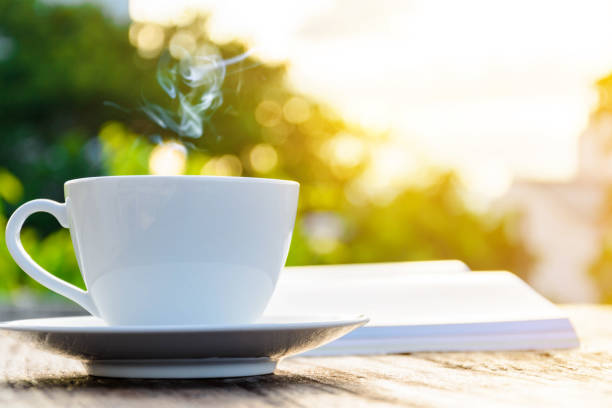 istock coffee cup clock and news paper on old wooden table 693770404