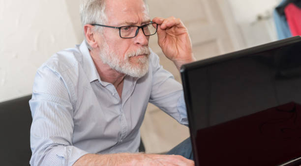 istock Modern mature man working on laptop 693777226