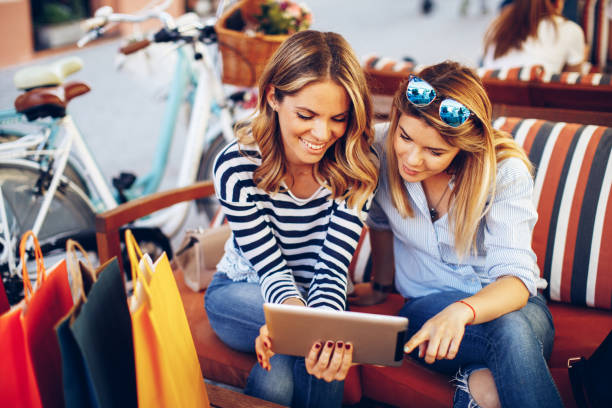 istock Two young women buying over the Internet via a digital tablet 693777896