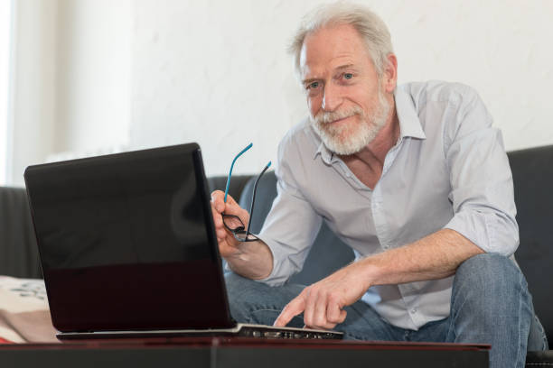 istock Modern mature man working on laptop 693781318