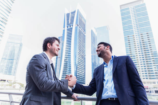 istock Business executives shaking hands to symbolize their cooperation towards a common goal 693781866