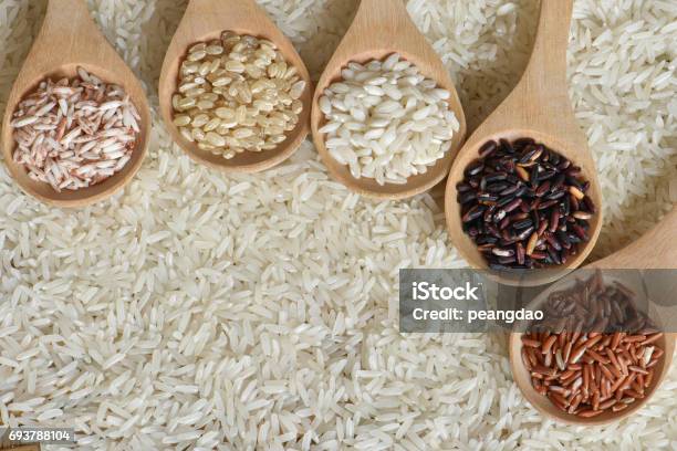 Top View Different Rice On Wooden Spoon Stock Photo - Download Image Now - Barley, Basmati Rice, Black Rice