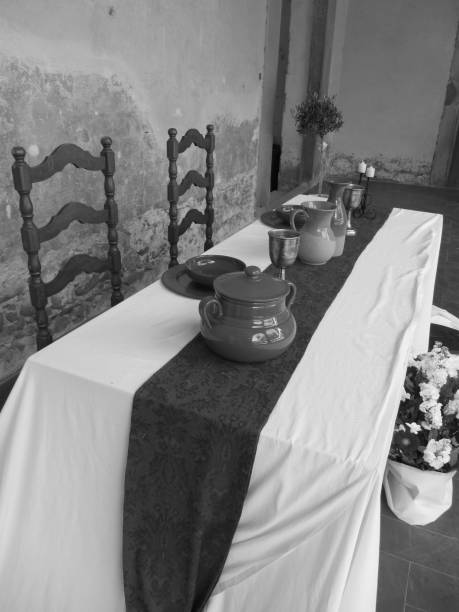 istock Table settings for a medieval style banquet . Black and white photo 693788574