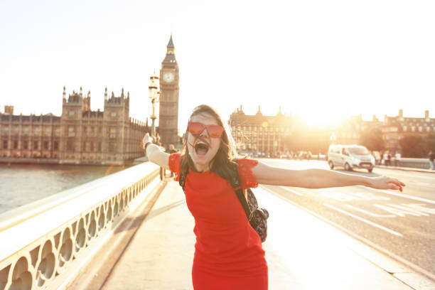 woman having fun at sunset - big ben london england uk british culture imagens e fotografias de stock