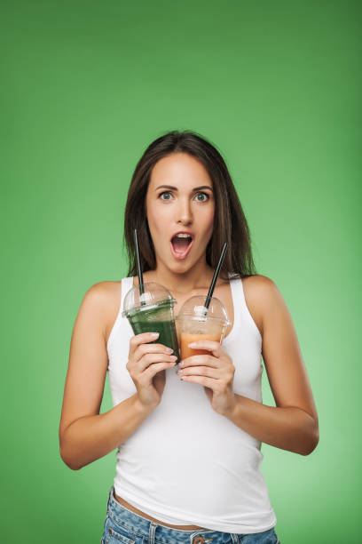 istock Young surprised woman holding smoothie 693792300