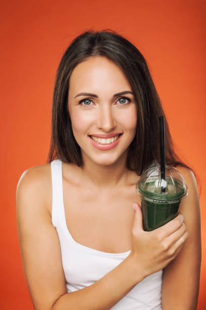 istock Happy smiling woman holding smoothie 693793276
