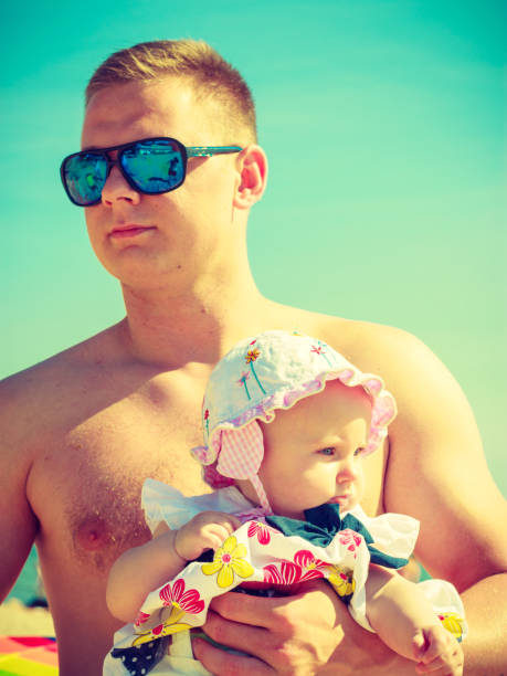istock Man posing with baby on summer 693794732