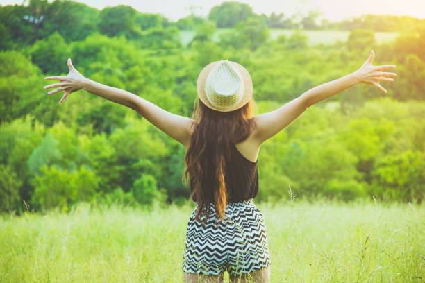 istock Woman rising hands up in the nature 693794802
