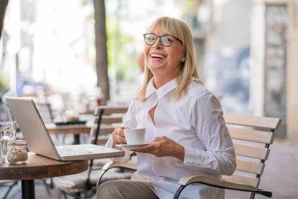 istock Mature woman working at cafe 693795370