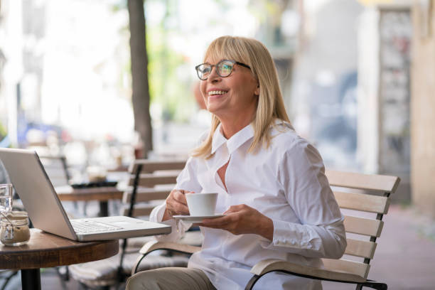 istock Mature woman working at cafe 693795386
