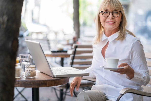 istock Mature woman working at cafe 693795890