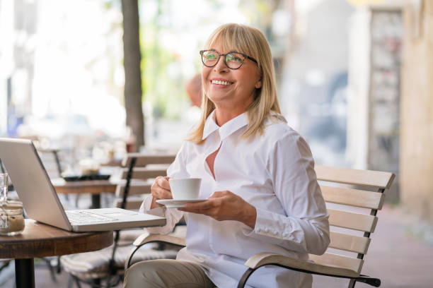 istock Mature woman working at cafe 693795900