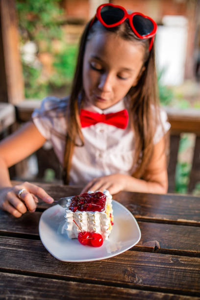 Pretty young girl eating cake