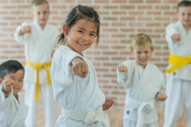 Little Girl Throws a Punch at Martial Arts Practice