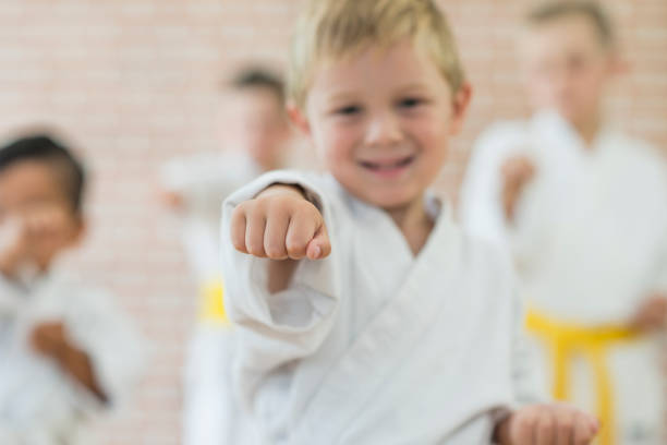 istock Boy Throwing a Punch at Martial Arts Practice 693798778